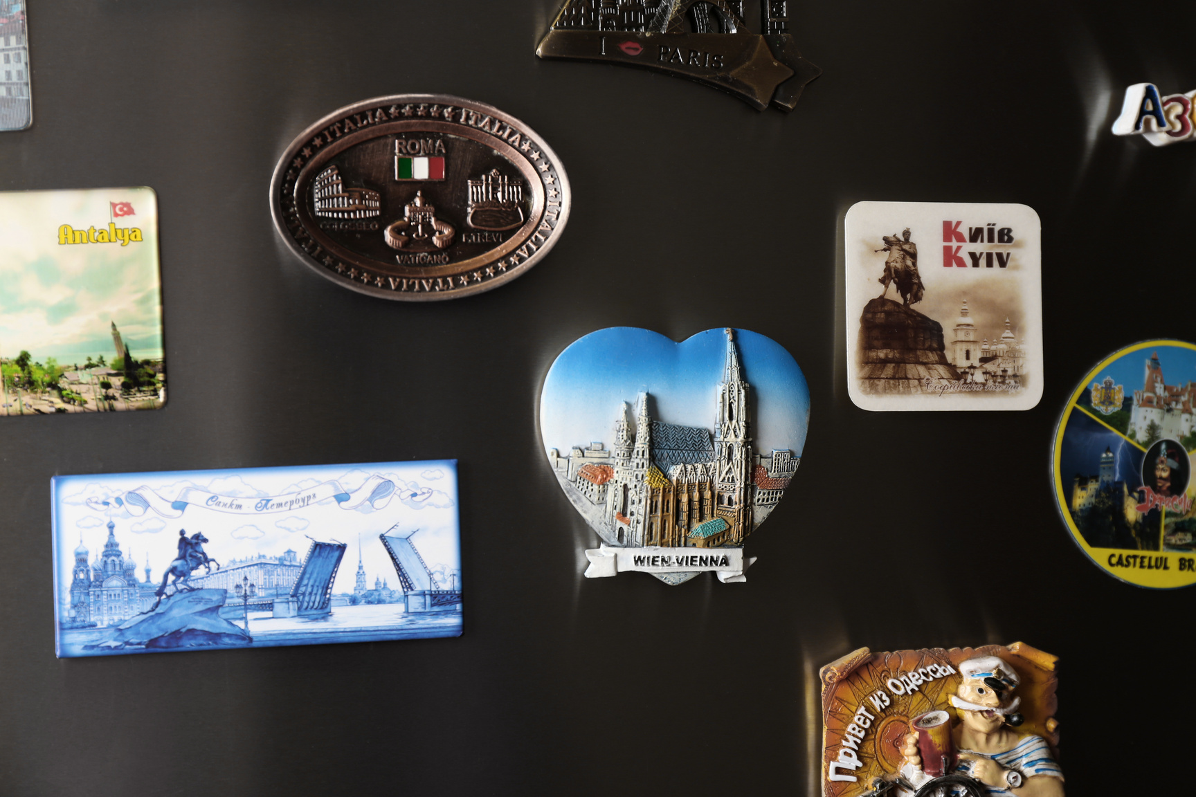 MYKOLAIV, UKRAINE - DECEMBER 25, 2018: Many Different Souvenir Magnets on Fridge Door